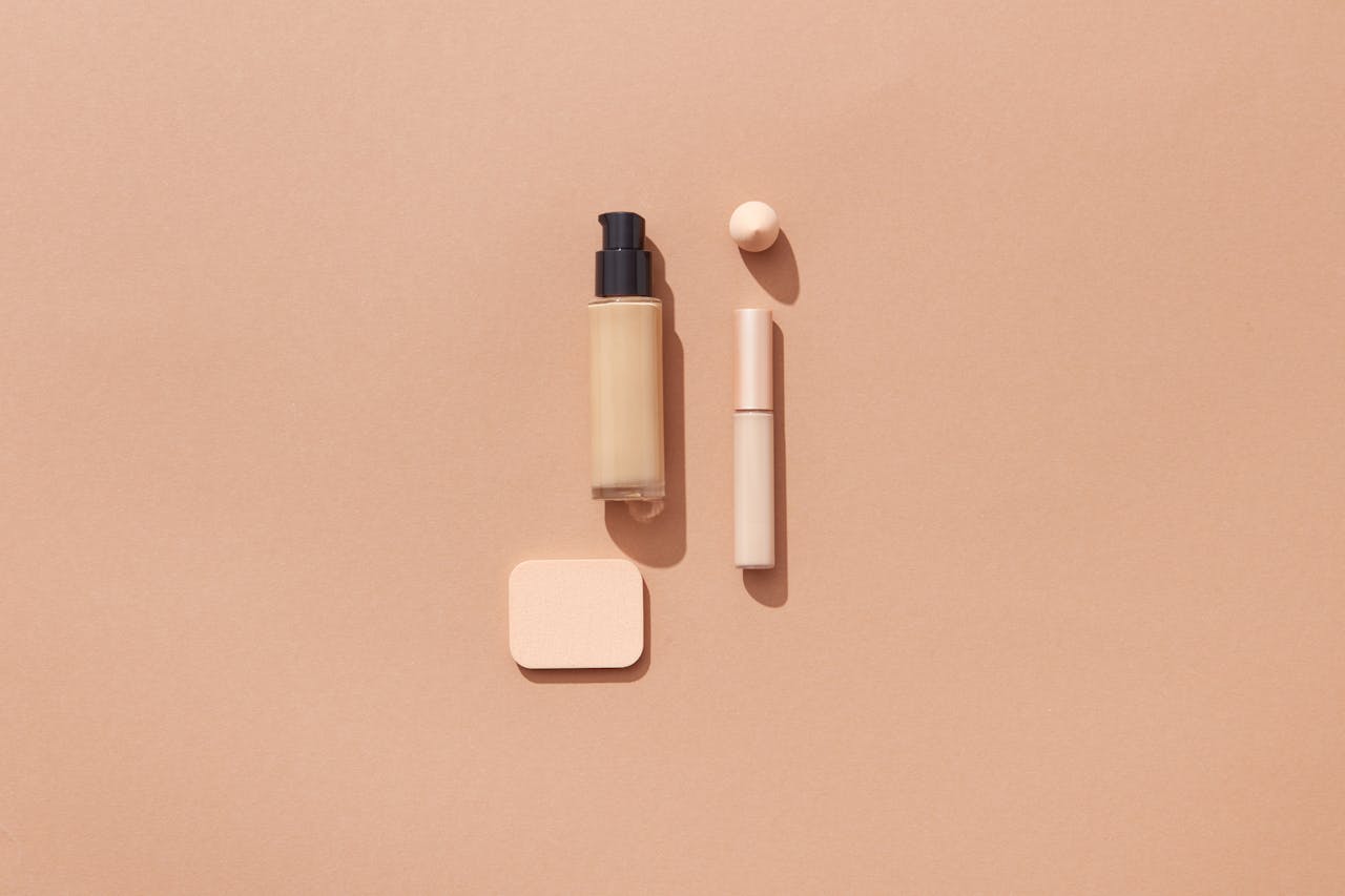 Flat lay of beauty products on a brown background with space for text, ideal for cosmetic promotions.
